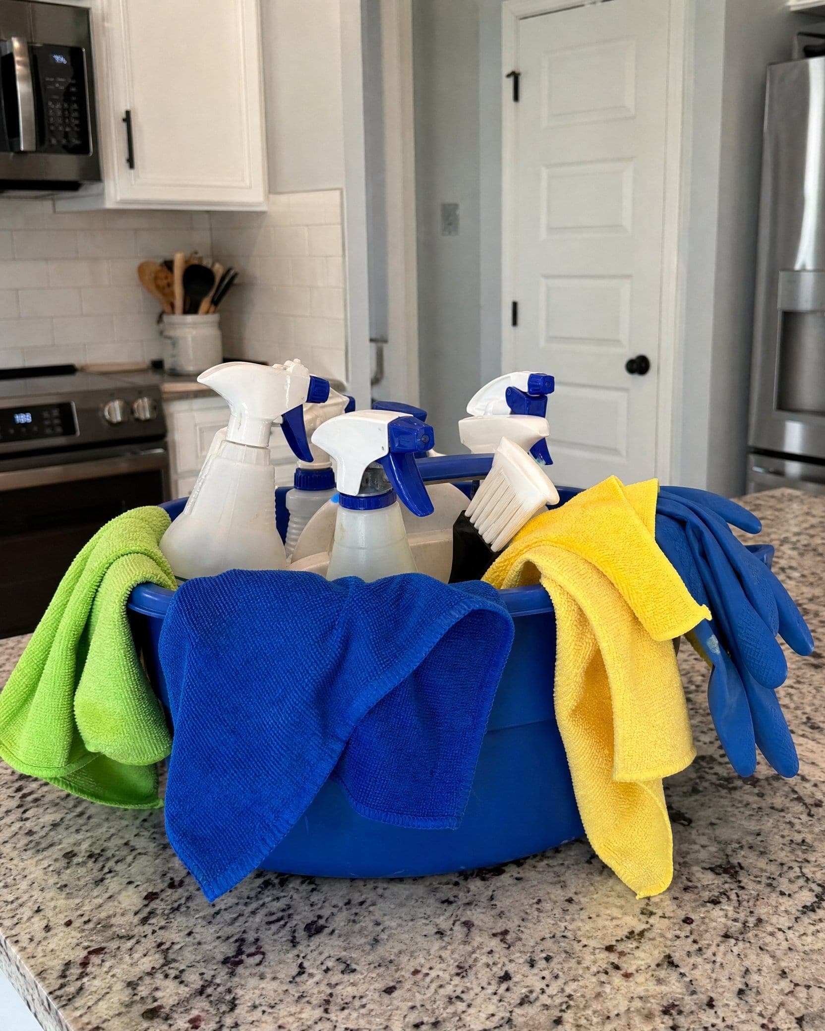 A basket of NovaSpark's cleaning supplies and microfiber cloths, ready for a job